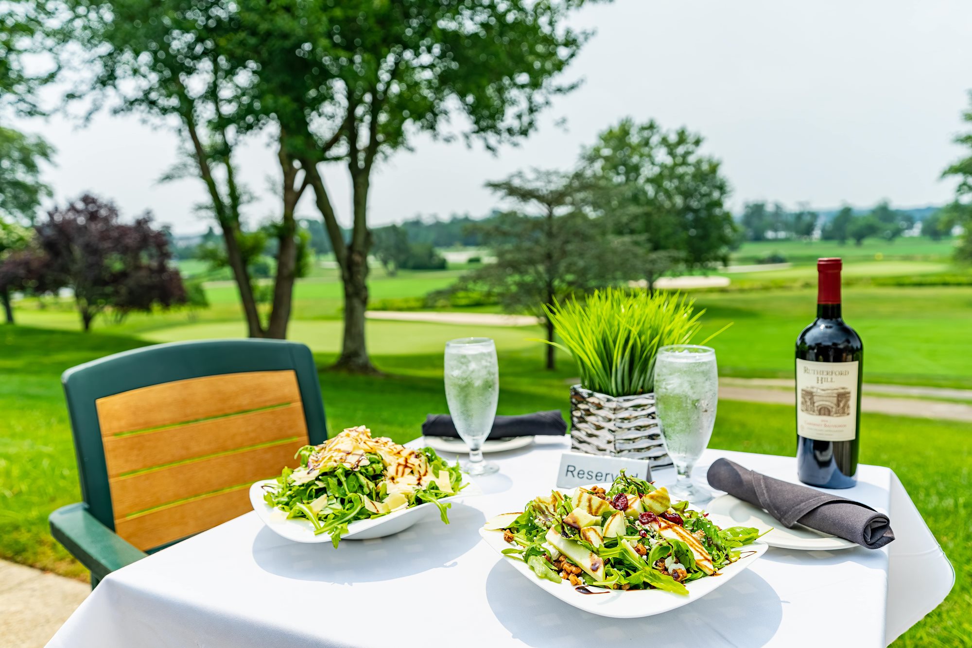 aerial_outside_dining_table_with_salads_and_wine-min